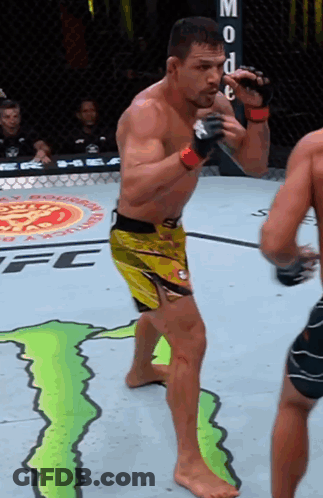 Man In Yellow Shorts In Front Of Monster Energy Ad GIF