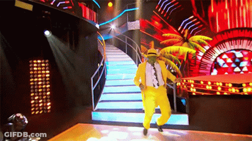 Man In Yellow Suit And Hat Dancing On Stage GIF