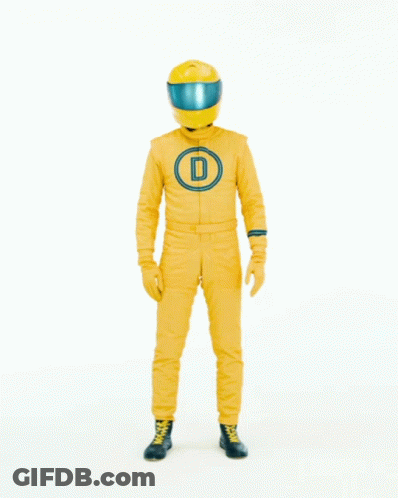Man In Yellow Suit And Helmet In Front Of Here Sign GIF