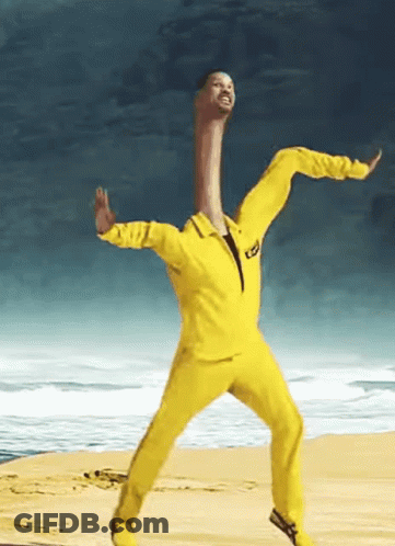 Man In Yellow Suit Dancing On Beach GIF
