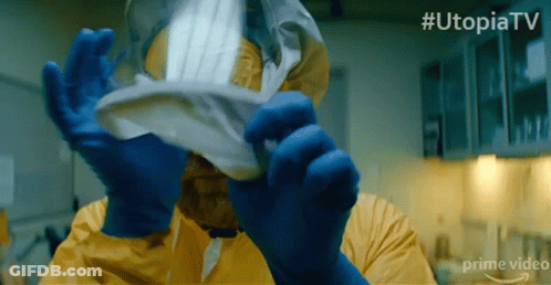 Man In Yellow Suit Holding Paper With Hashtag Utopiatv GIF