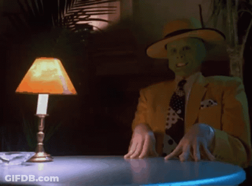 Man In Yellow Suit Sitting At Table GIF