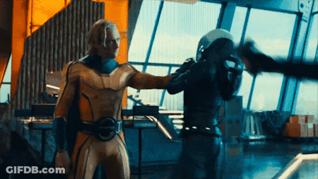 Man In Yellow Superhero Suit Next To Man GIF