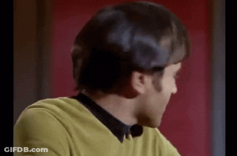 Man In Yellow Sweater And Black Shirt Smiling At Camera GIF
