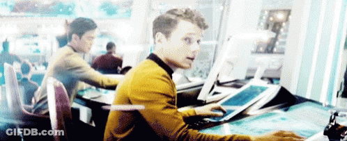 Man In Yellow Sweater At Desk With Computer GIF