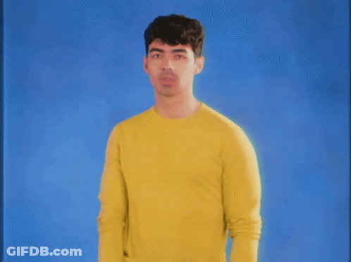 Man In Yellow Sweater Blue Background GIF