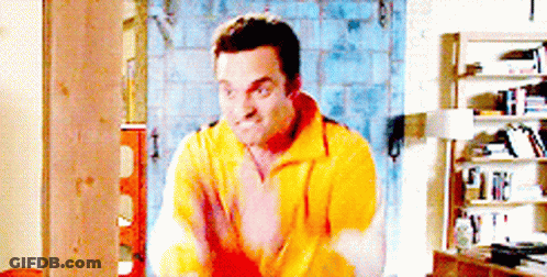 Man In Yellow Sweater By Bookshelf GIF