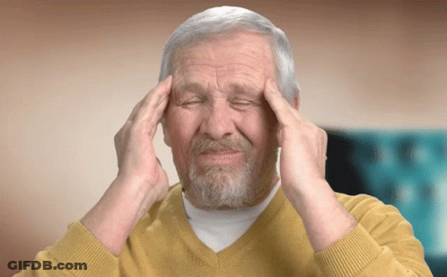 Man In Yellow Sweater Hands On Head Eyes Closed GIF