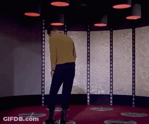 Man In Yellow Sweater Under Red Lights GIF