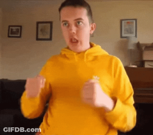 Man In Yellow Sweatshirt Making Funny Face GIF
