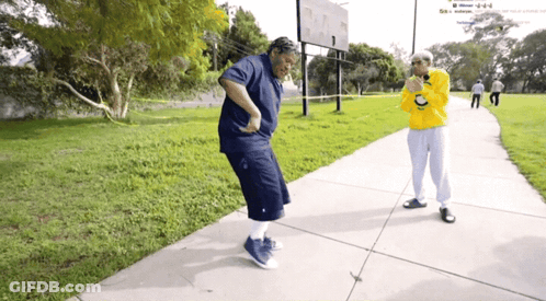 Man In Yellow Sweatshirt With Letter C Next To Woman In Blue GIF