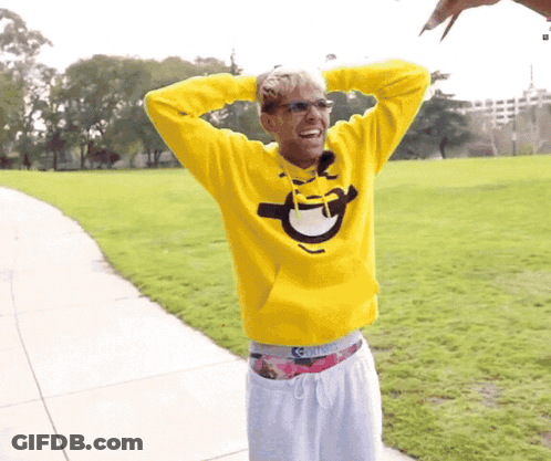 Man In Yellow Sweatshirt With Smiley Face GIF