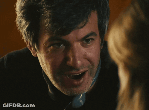 Man In Yellow Sweatshirt With Smiley Face GIF