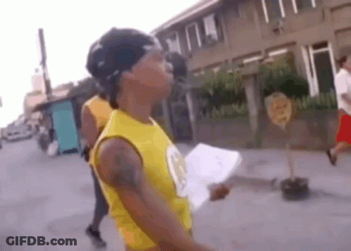 Man In Yellow Tank Top Holding Paper GIF