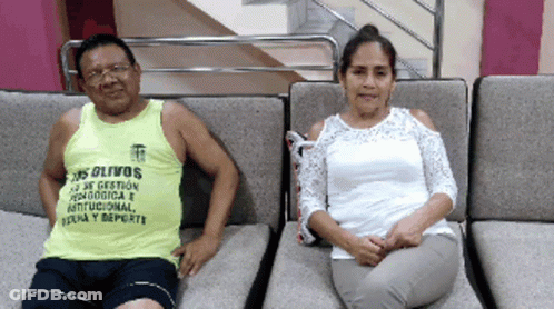 Man In Yellow Tank Top Los Olivos Sits Next To Woman In White Top GIF