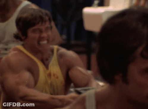 Man In Yellow Tank Top With Letter G Smiling GIF