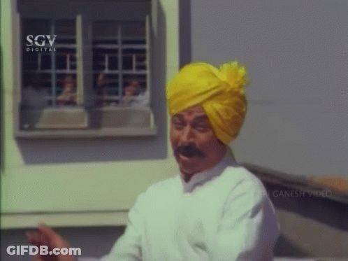 Man In Yellow Turban And White Shirt GIF