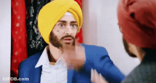 Man In Yellow Turban Talking To Another Man GIF