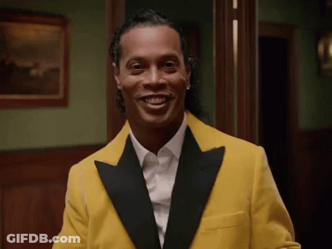 Man In Yellow Tuxedo And White Shirt Smiling GIF