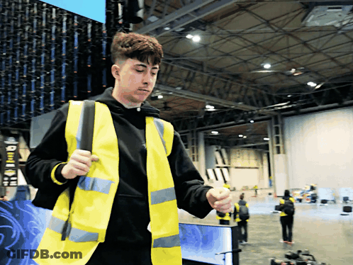 Man In Yellow Vest And Black Hoodie GIF