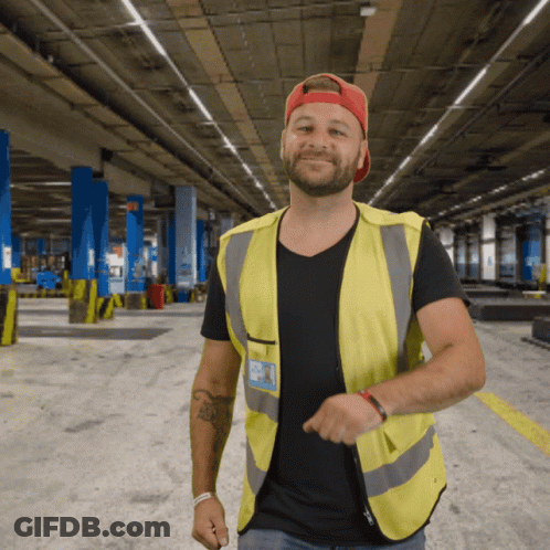 Man In Yellow Vest And Black Shirt With A.J. Name Tag GIF