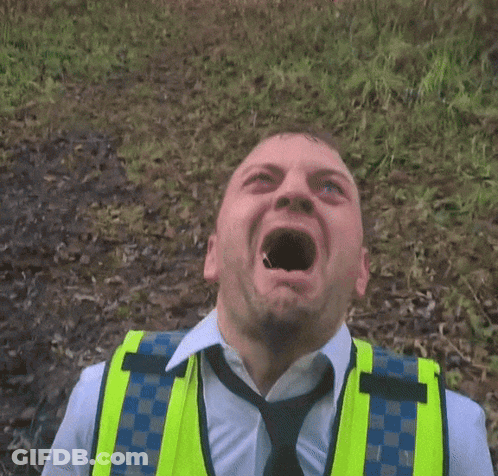 Man In Yellow Vest And Tie Making Face GIF