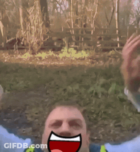 Man In Yellow Vest And Tie With Cartoon Face Drawn On Face GIF