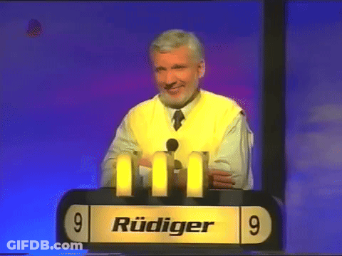 Man In Yellow Vest At Podium With Number 9 GIF