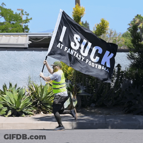 Man In Yellow Vest Running With Flag Saying I Suck At Fantasy Football GIF