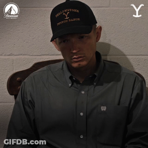 Man In Yellowstone Hat Sitting In Chair GIF