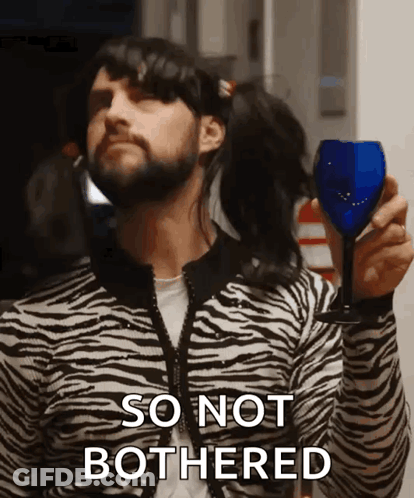 Man In Zebra Print Sweater Holding Wine Saying So Not Bothered GIF