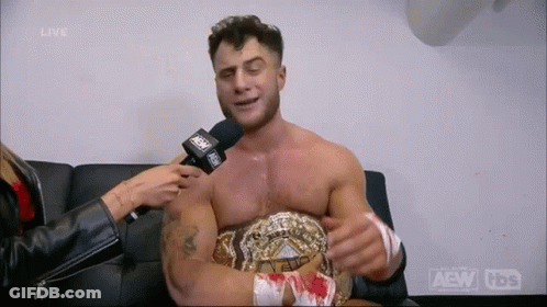 Man Interviewed By Woman While Wearing Wrestling Belt GIF