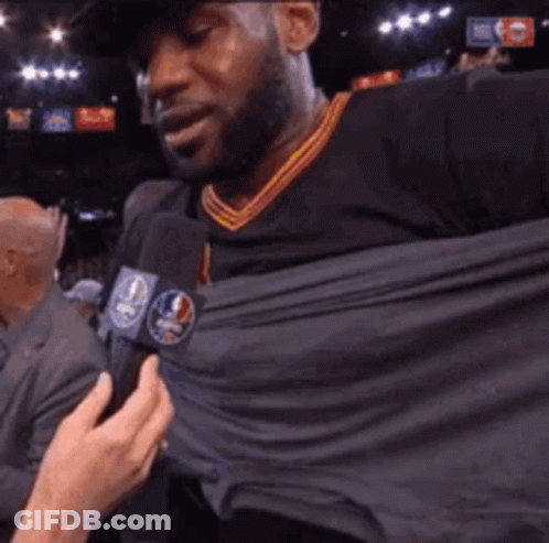 Man Interviewed With Shirt Pulled Up GIF
