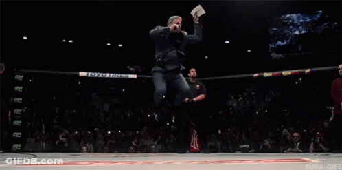 Man Jumping Holding Paper Saying UFC GIF