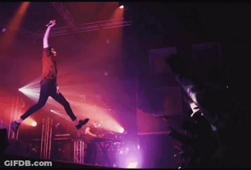 Man Jumping In Air With Microphone GIF