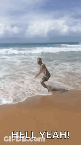Man Jumping Into Ocean Saying Hell Yeah GIF