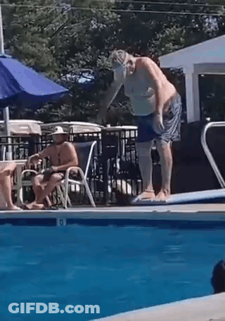 Man Jumping Into Pool While Another Sits On Chair GIF
