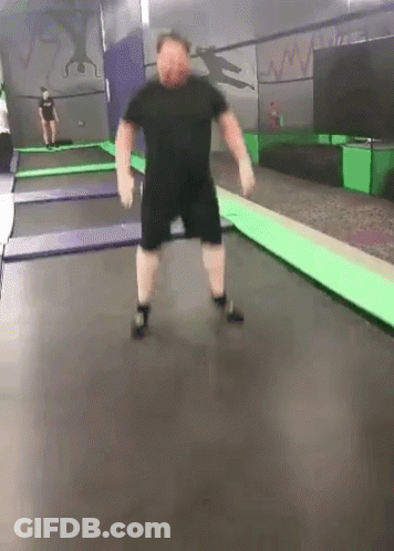 Man Jumping On Trampoline With Another Watching GIF