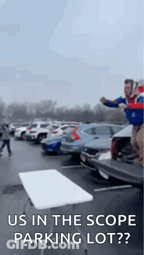 Man Jumping Over Table In Parking Lot Saying Us In The Scope Parking Lot? GIF