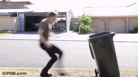 Man Jumping Over Trash Can In Front Of House GIF