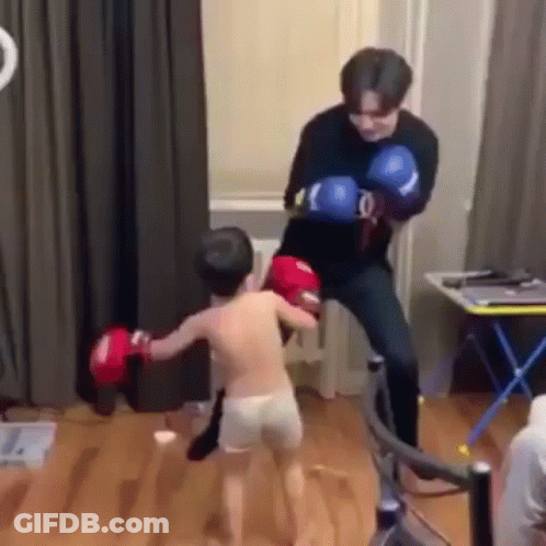 Man Kicking Boy In Face With Boxing Gloves GIF