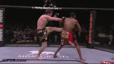 Man Kicking Opponent In Boxing Ring GIF