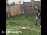 Man Kicking Soccer Ball In Grass GIF