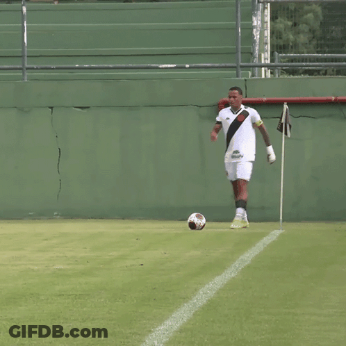 Man Kicking Soccer Ball On Green Field GIF