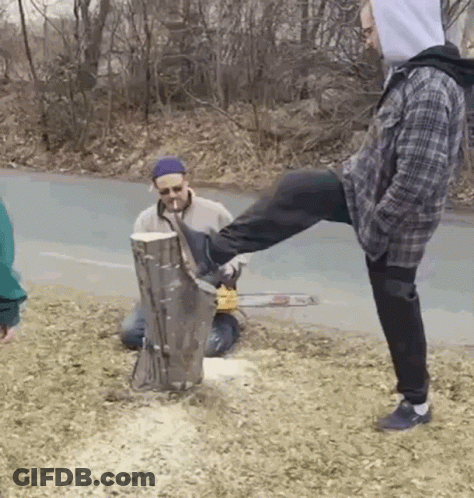 Man Kicking Tree Stump With Chainsaw, Another Watching GIF