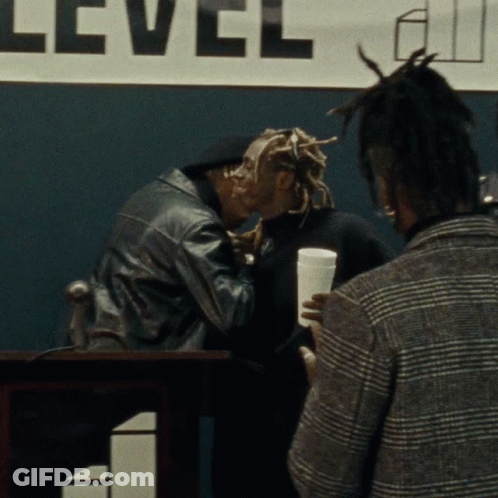 Man Kissing Another Man At Level Sign GIF