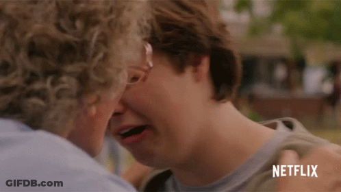 Man Kissing Another Man's Forehead With Netflix Logo GIF