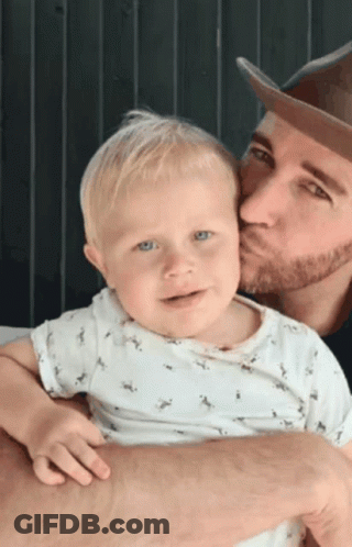 Man Kissing Baby On Cheek GIF