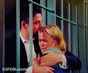 Man Kissing Woman Behind Bars In Jail Cell GIF