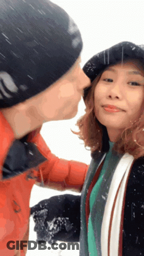 Man Kissing Woman On Cheek GIF
